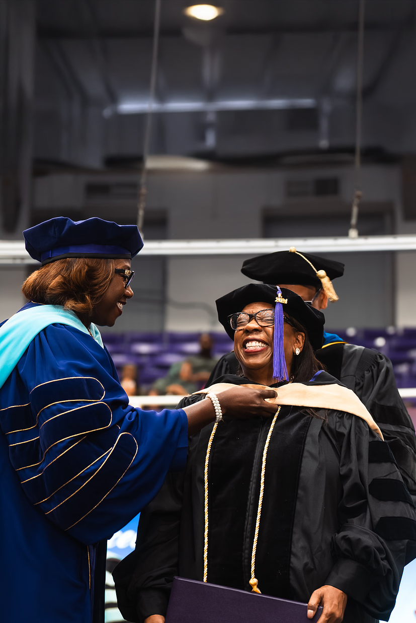 Three PVAMU students standing on the stairs in the College of Business building