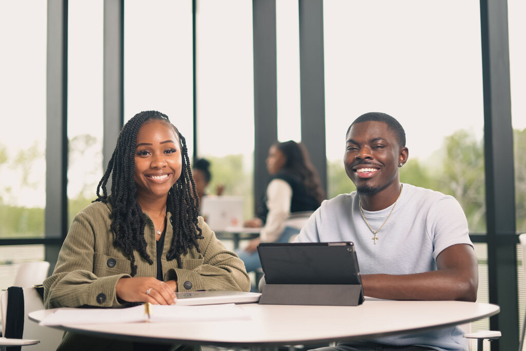 Two PVAMU undergraduate students sitting at a table in the Business building