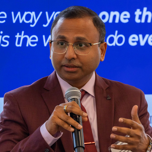 Magesh Rajan speaking at a seminar
