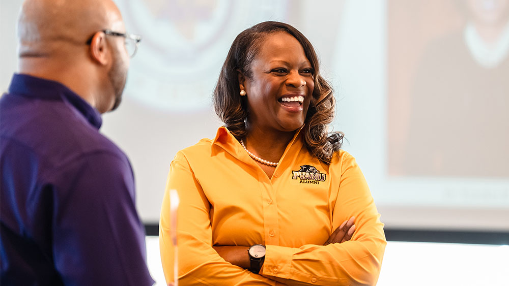 PVAMU Alum in yellow alumni branded polo shirt.