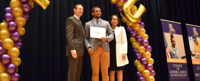 Interim Provost James M. Palmer (left) and AVP Michelle Hill (right) with a scholarship recipient.