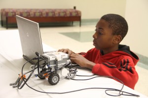 Boy in Red Hoodie Using HP Computer