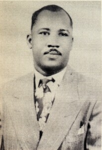 Alfred N. Poindexter Jr in suit with flowery tie, grayscaled