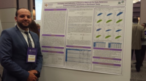 Yassine Cherif next to his poster at the symposium
