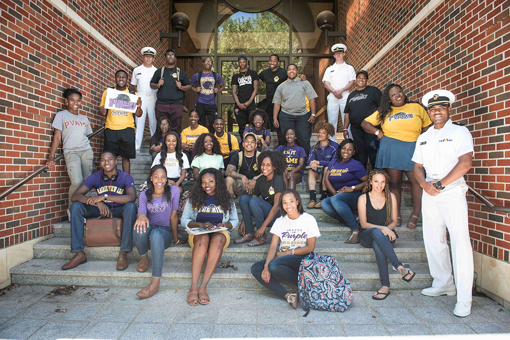 Group of PVAMU students gathered around a stairway into a building