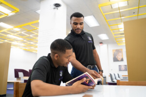 Two students studying in the library.
