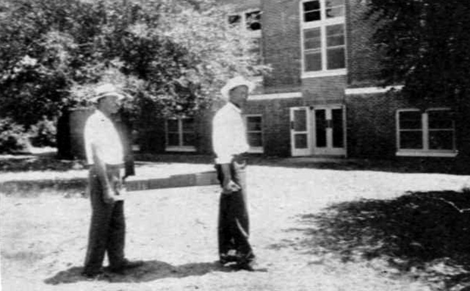 Mr. G. L. Smith and Mr. O. Thomas are carrying books