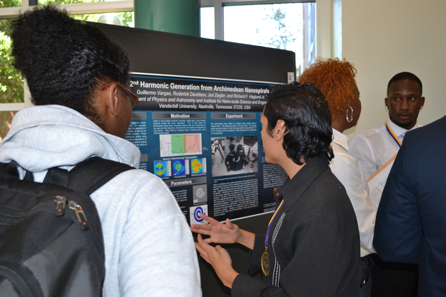 several people talking at display boards