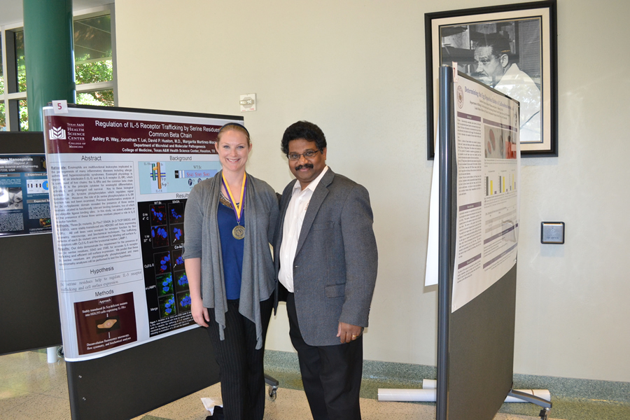 professor and student in front of display board.