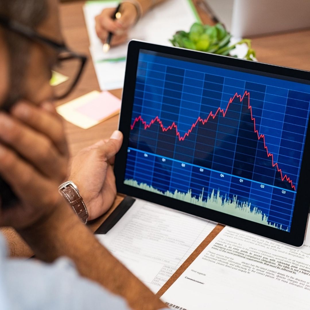 Stock Market Man looking at stocks on Ipad