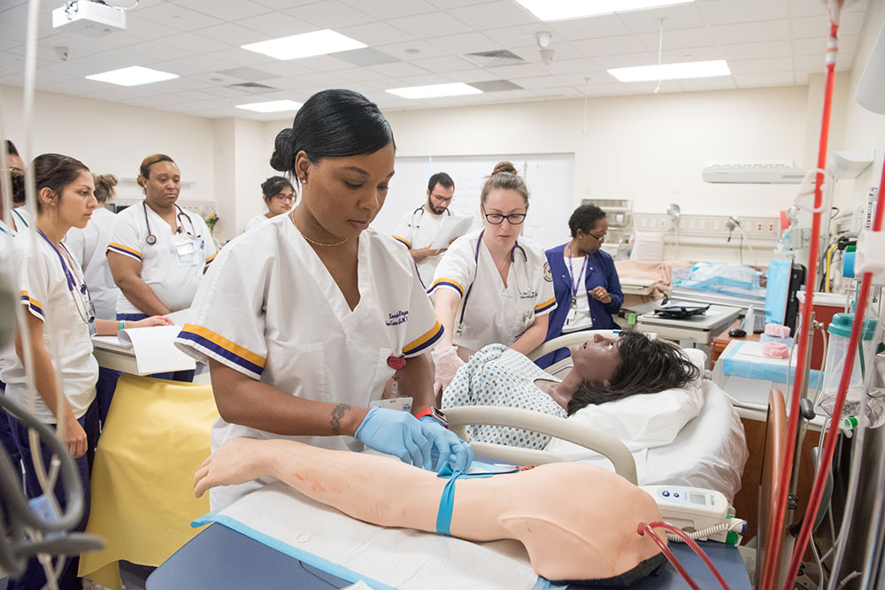 Nursing students practicing on a dummy patient