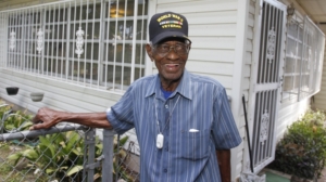 Richard Overton, the oldest recorded living US veteran, surveys the backyard of his home in Austin, Texas. He served for the Army in the Pacific during World War II. (Credit: Jack Plunkett / AP Images for Philips Lifeline)