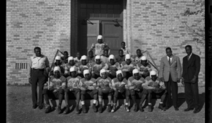 The Dunbar High School football team about 1940 wore uniforms and helmets passed down to them by Lubbock High School. (Provided by Southwest Collection/Texas Tech)
