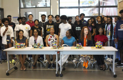 Group of students gathered at the table with the dean of architecture.