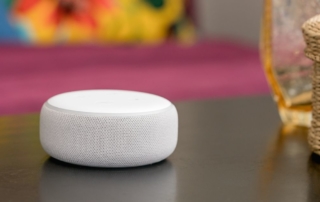 white alexa dot on table
