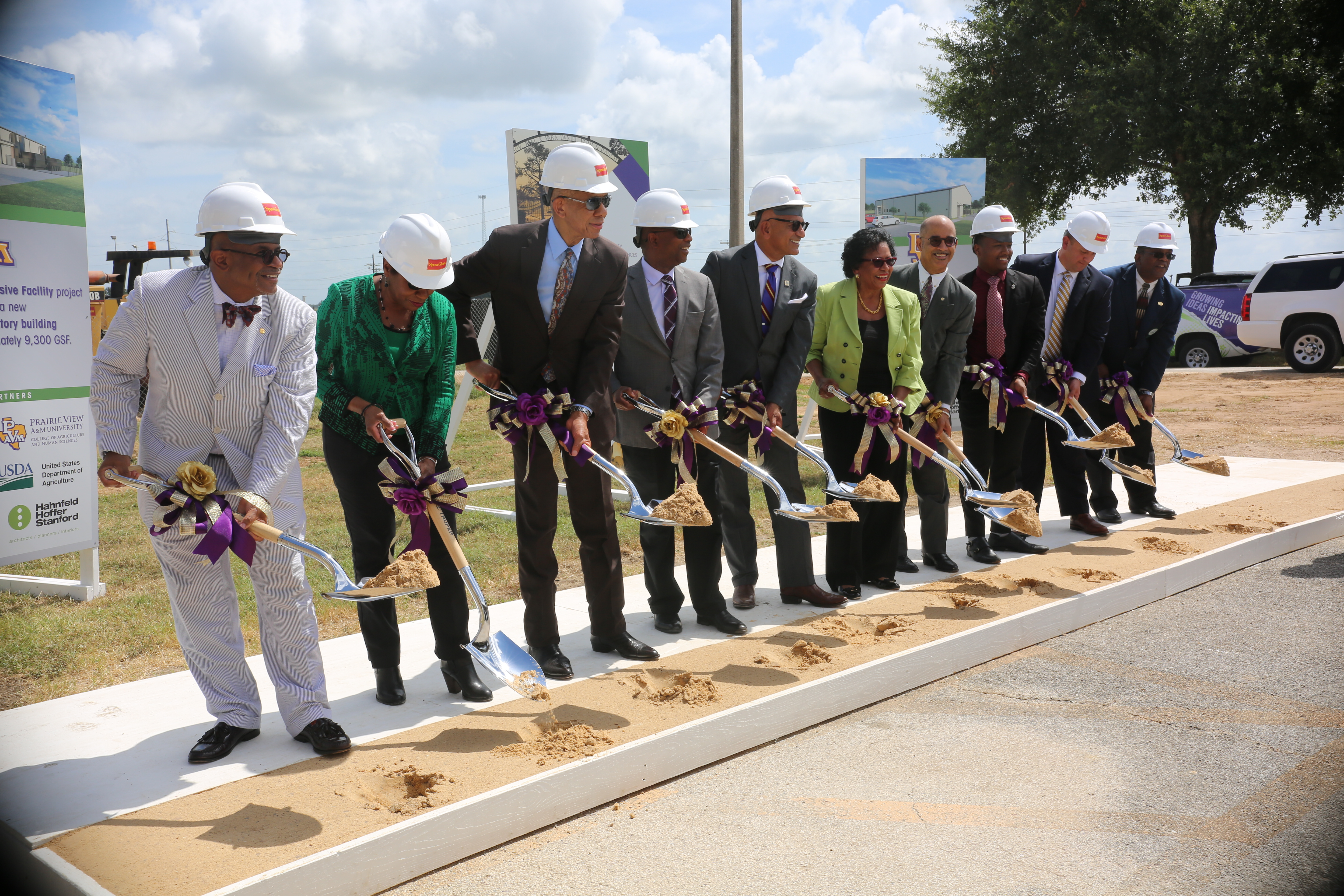 members of the CAHS and University holding shovels of dirt