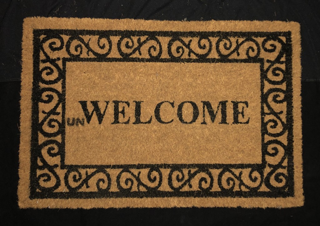 "Unwelcome" mat, which is part of Ann Johnson's art.