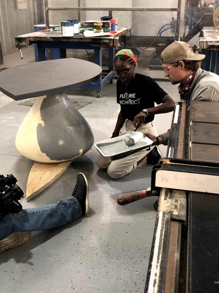 Adjorlolo paints alongside David Goltz, director of the Automated Fabrication & Design Lab at Texas A&M University.