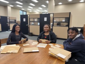 Archival Assistants Hannah Harden (left) and team leaders Lindsay Boknight (center) and Noah Jackson processing the Cooperative Extension & Home Demonstration Collection. (Photo: T. DeWayne Moore, 2022)