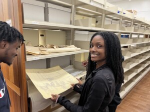 Archival Assistants Hannah Harden (left) & Noah Jackson examine a map of the city of Prairie View from the 1980s. (Photo: T. DeWayne Moore, 2022)