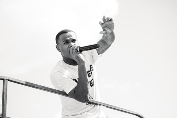 A student speaking into a microphone at a rally